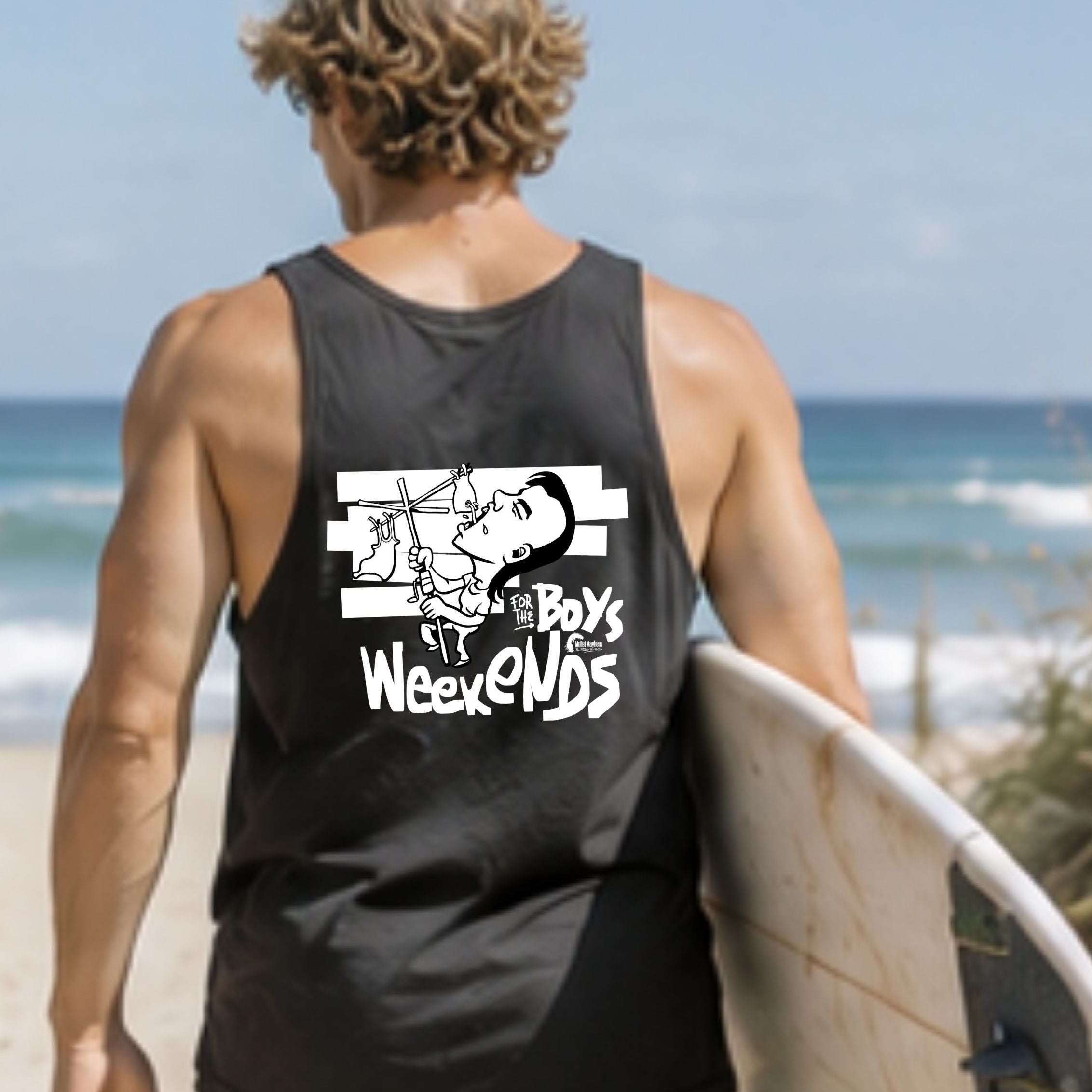 A man on a beach seen from behind wearing a black tank top with a white graphic that reads 'Pys Weekends' and carrying a surfboard.